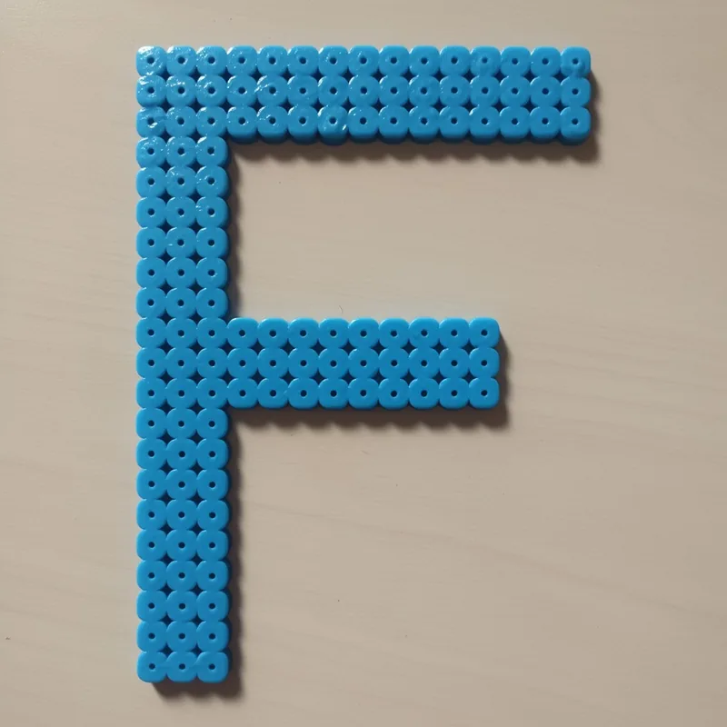 Letter F beaded in fuse beads, 29x29 pegs