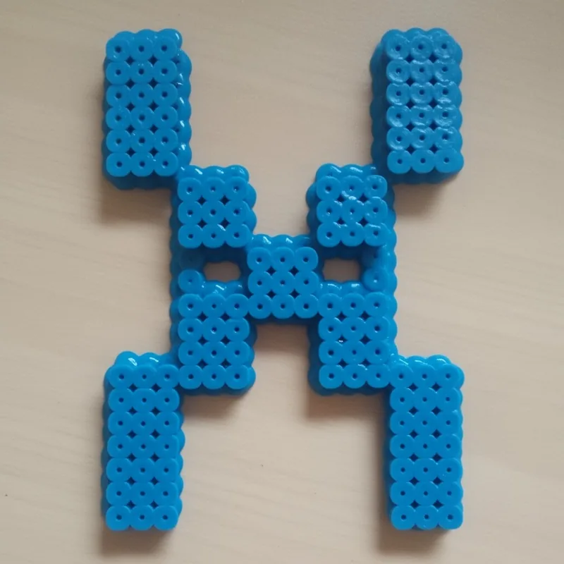 Letter X beaded in fuse beads, 29x29 pegs